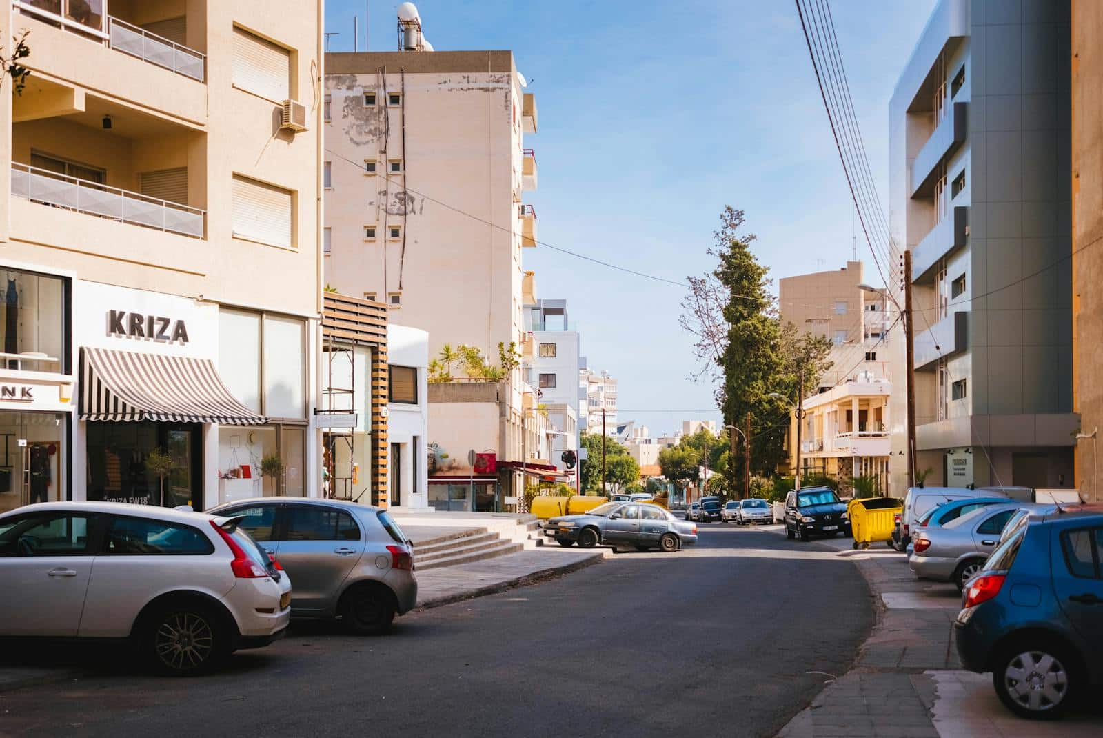 Cars Parked In Front Of Buildings