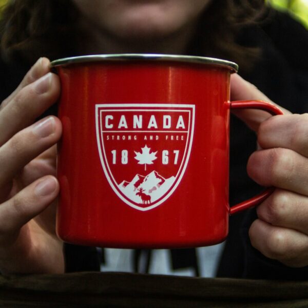 person holding red metal mug